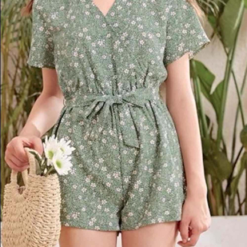 A floral romper, comes with belt and very fitted. for kids.